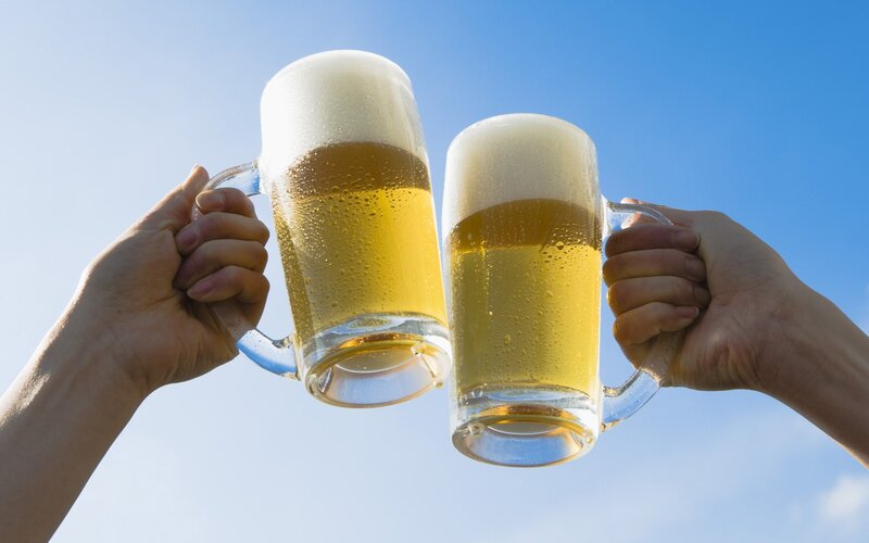 Two Hands Clinking Beer Mugs — Blue, Celebratory, Afternoon, Photograph, Beer Mugs, Sky