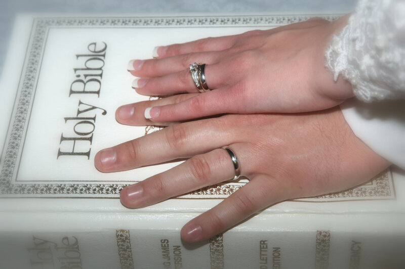 Two Hands on a Bible