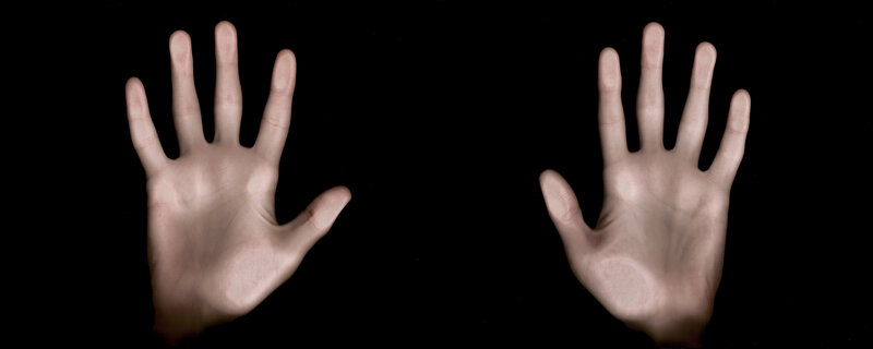 two hands on black background