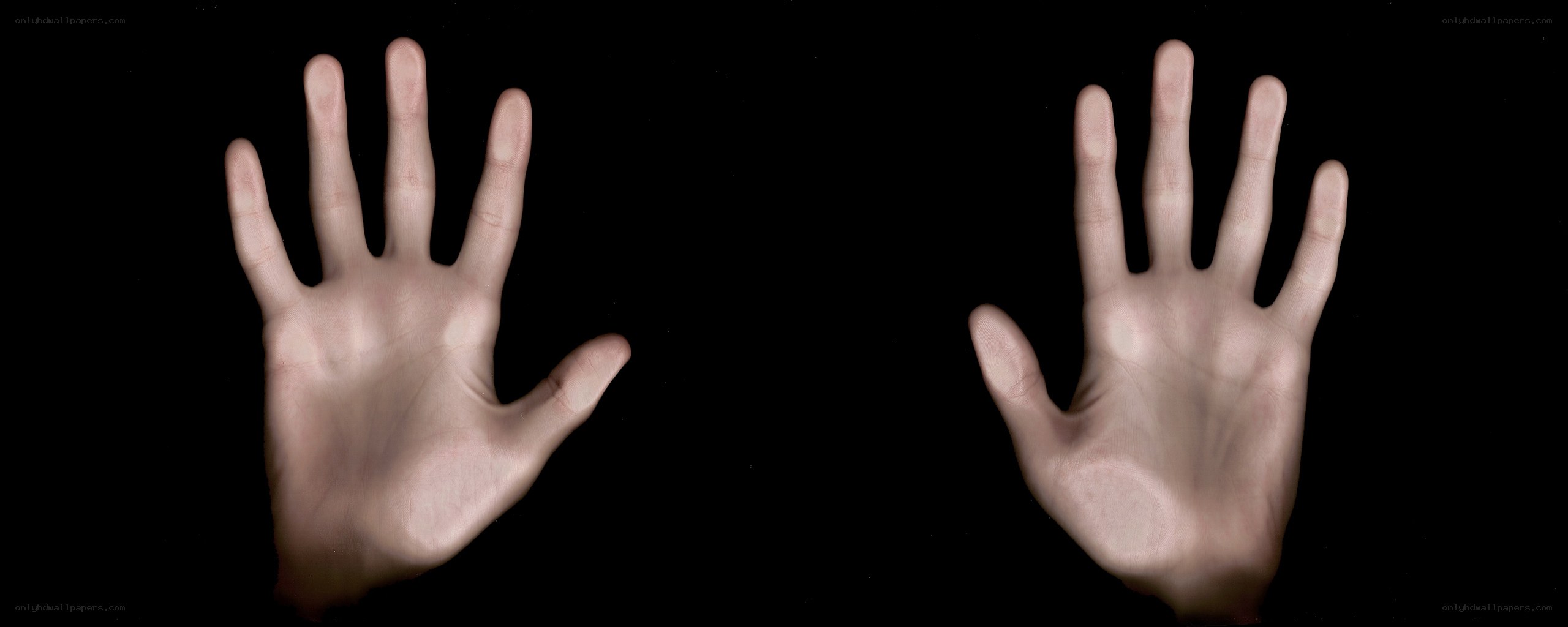 two hands on black background