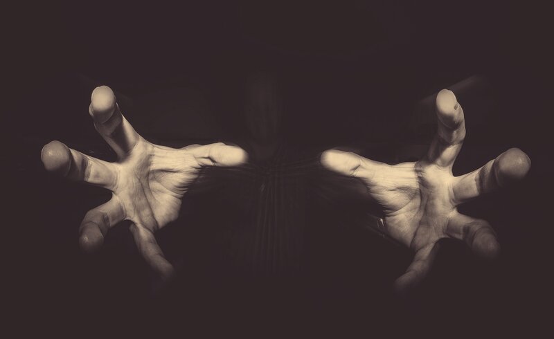 Two Hands Reaching Forward