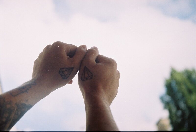 Two Hands with Tattoos