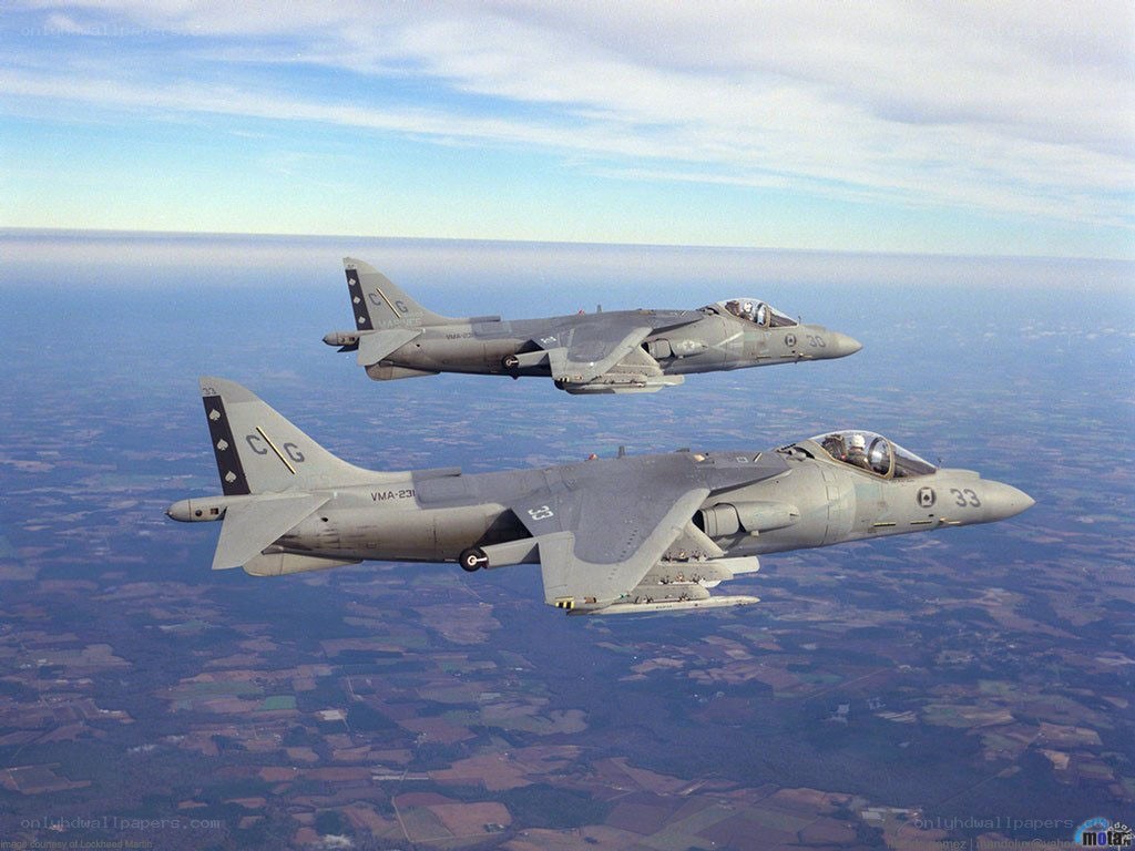 Two Harrier jets in flight