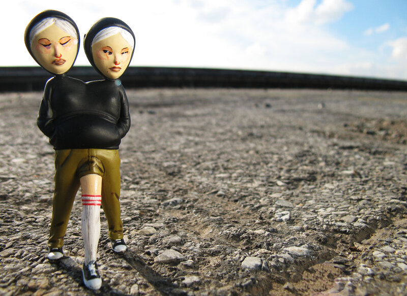 Two-headed figurine on gravel