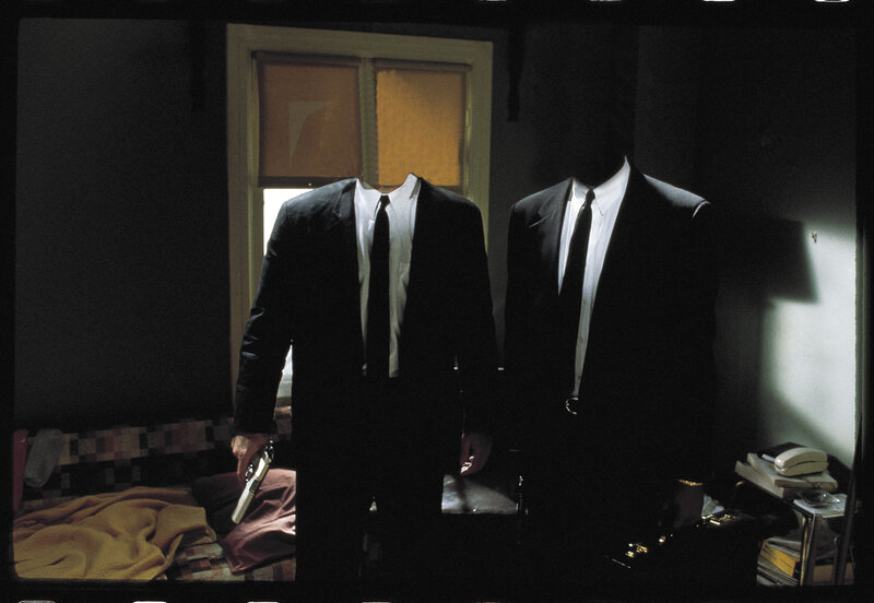 Two headless men in suits