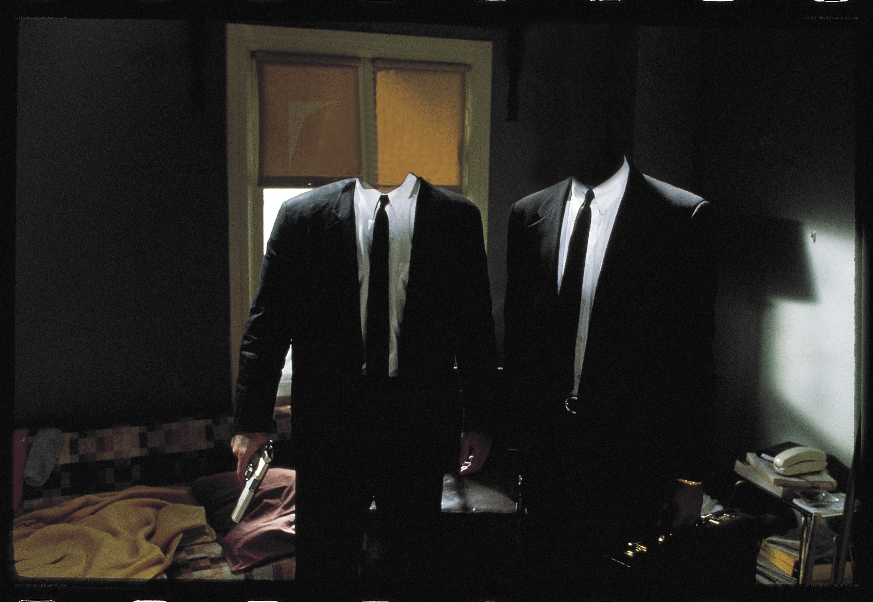 Two headless men in suits