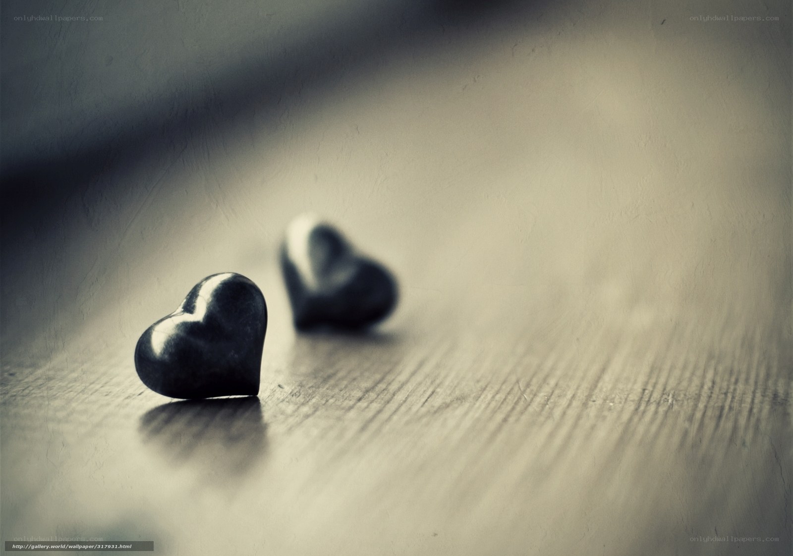 Two hearts on wooden surface