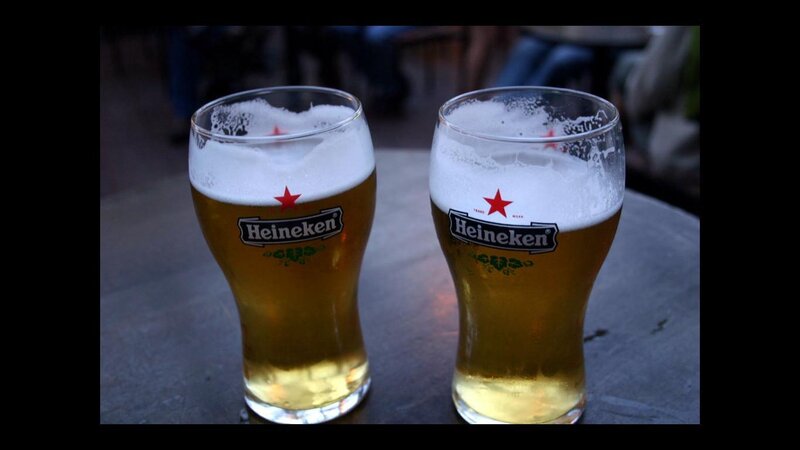 Two Heineken beers on a table