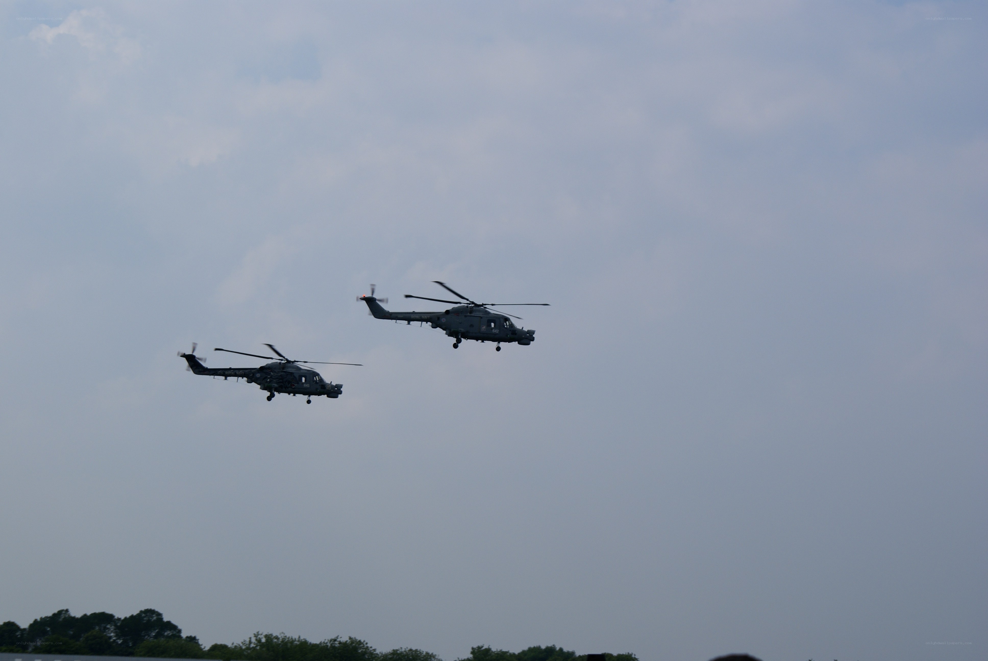Two helicopters in flight