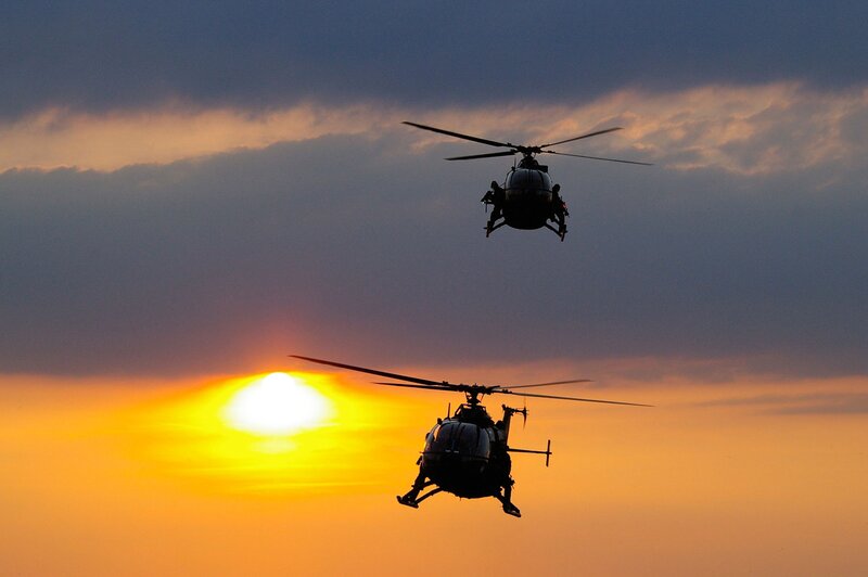 Two Helicopters in Flight — Orange, Dramatic, Sunset