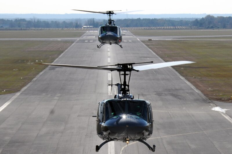 Two helicopters on a runway