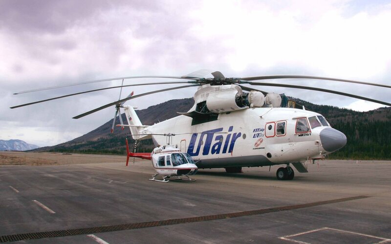 Two Helicopters on Tarmac — White, Overcast