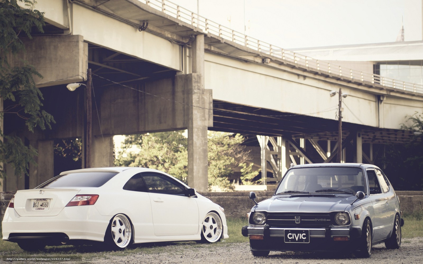 Two Honda Civics under a bridge