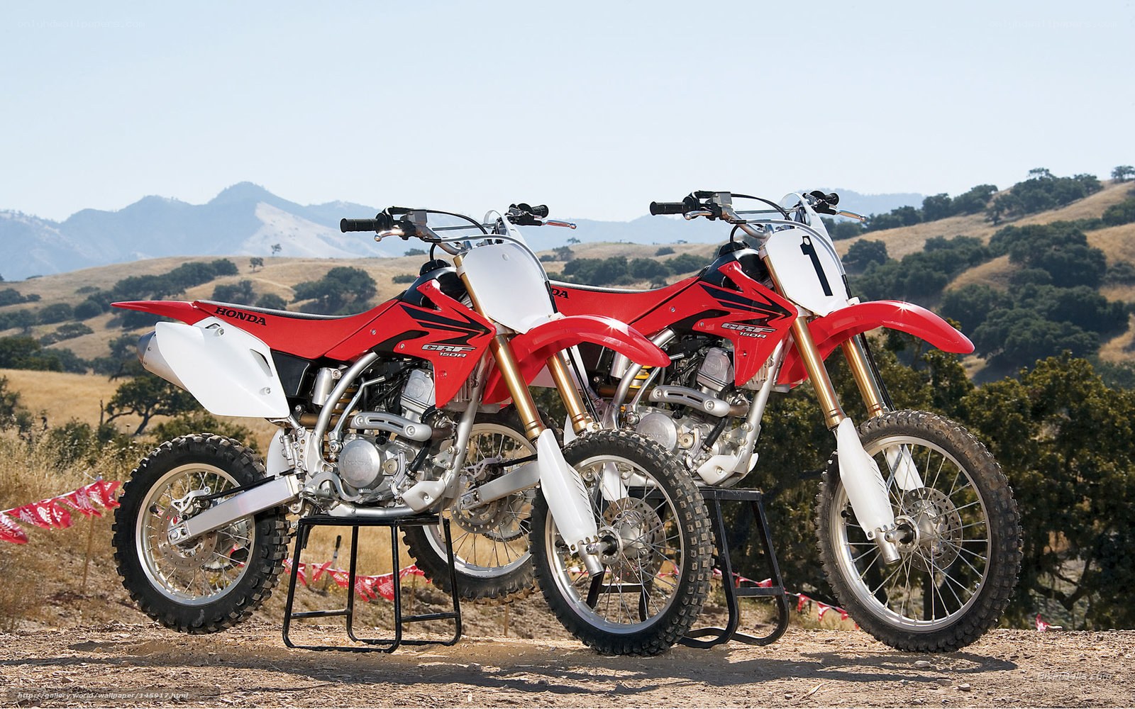 Two Honda dirt bikes on display