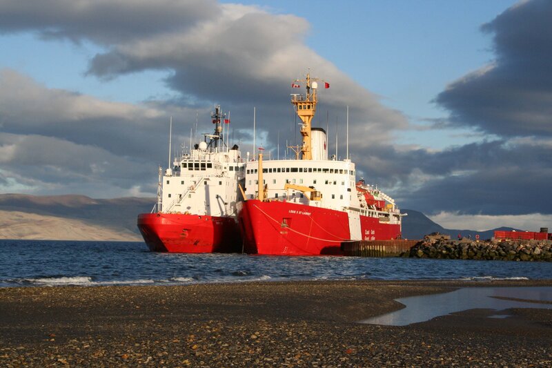 Two icebreakers docked at a port