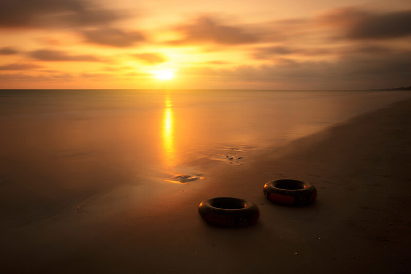 Two Inner Tubes on Beach