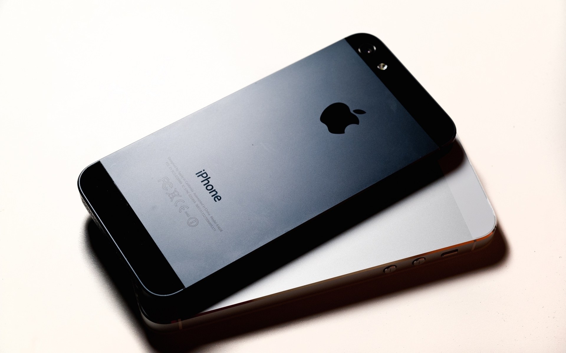 Two iPhones on a white surface