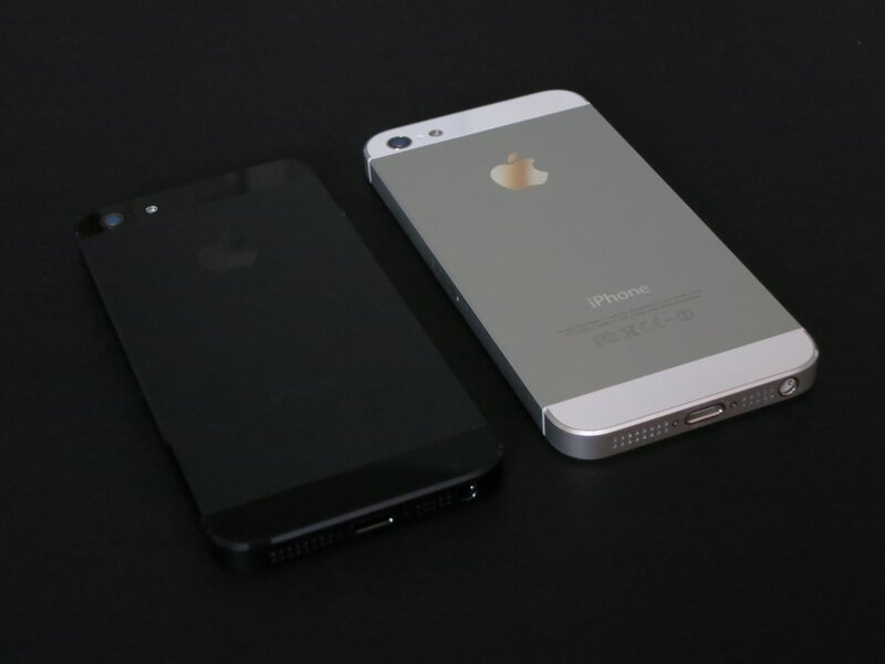 Two IPhones on Black Surface — Neutral