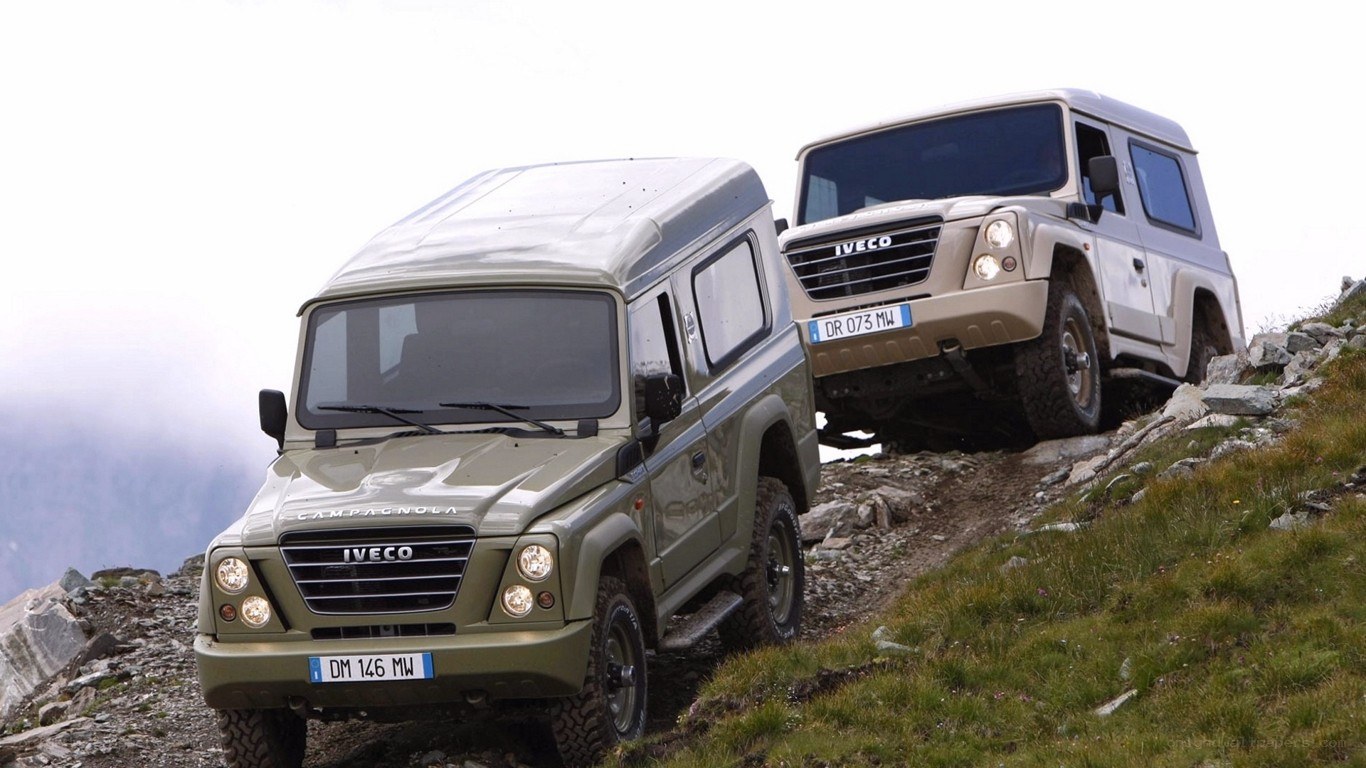 Two IVECO off-road vehicles on a mountain