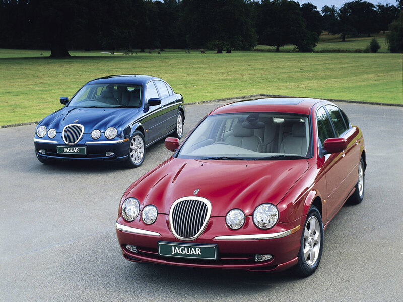 Two Jaguar sedans on a driveway