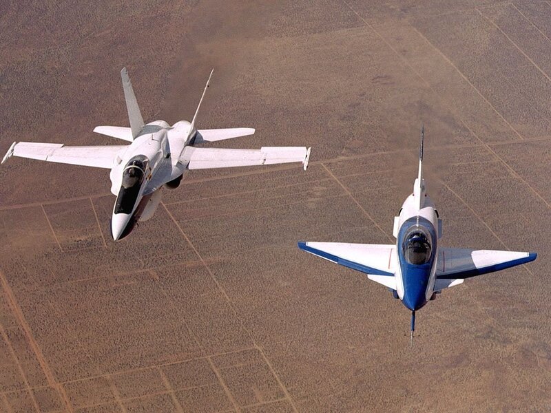 Two jets flying over desert