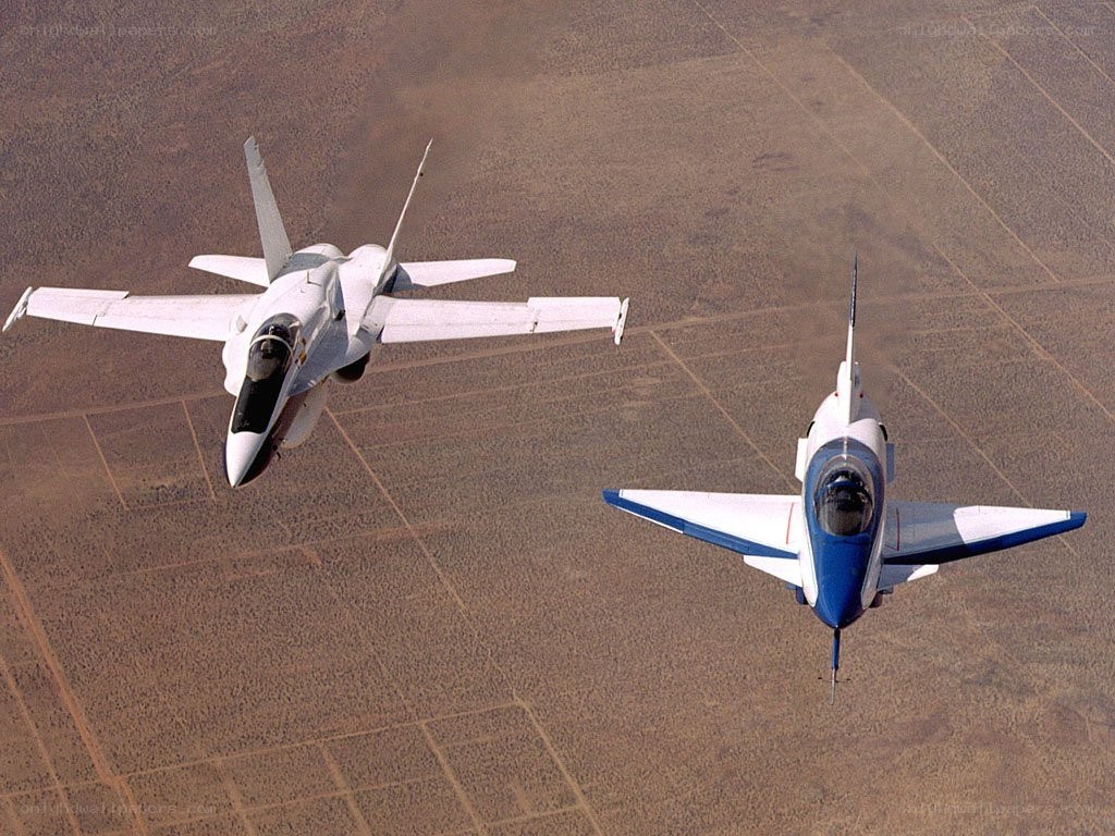 Two jets flying over desert