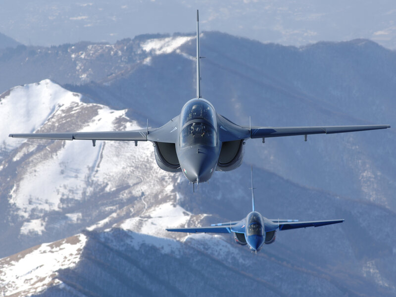 Two jets flying over mountains