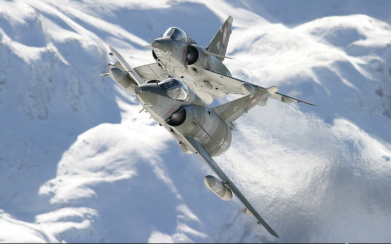 Two jets flying over snow