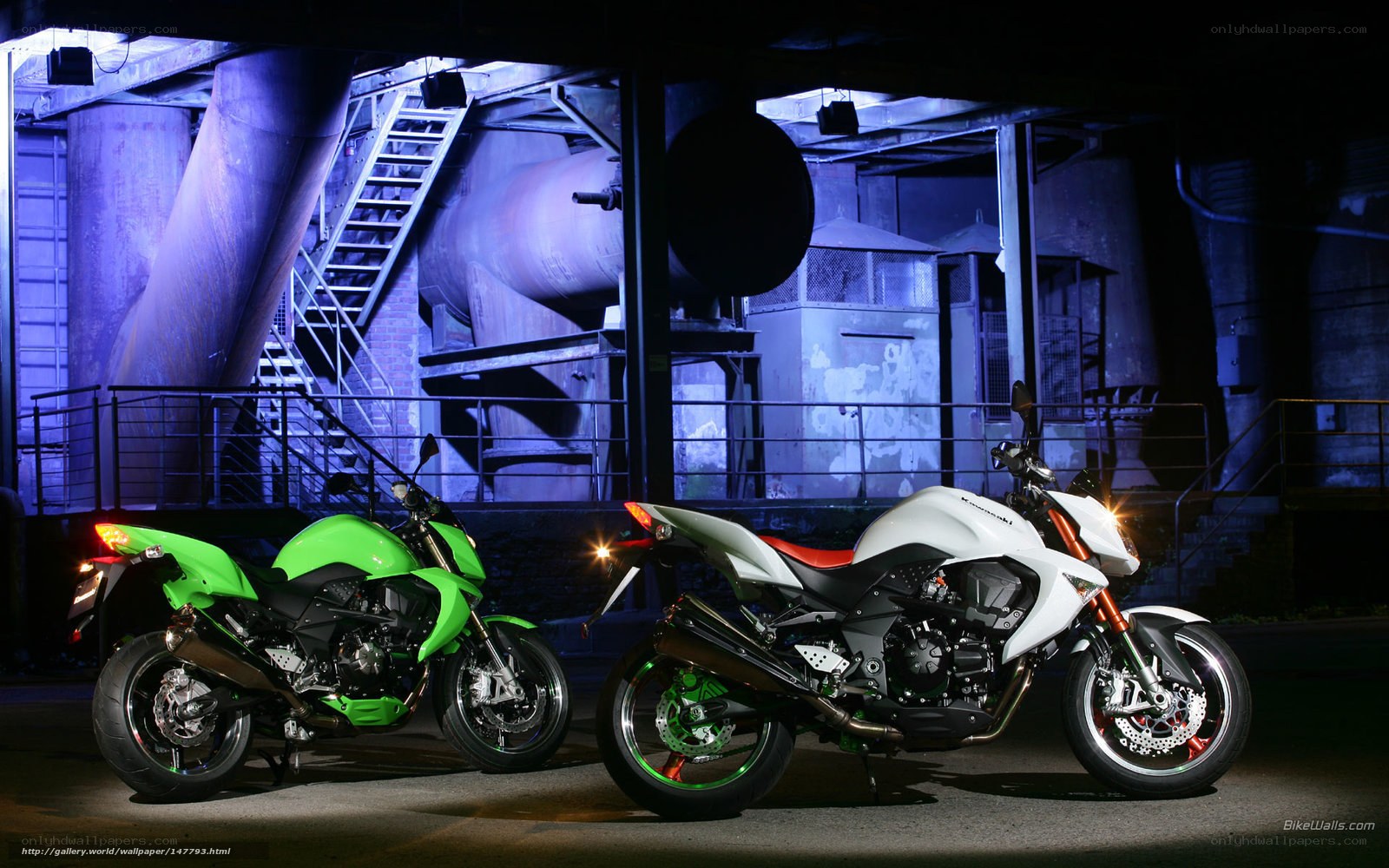 Two Kawasaki motorcycles at night
