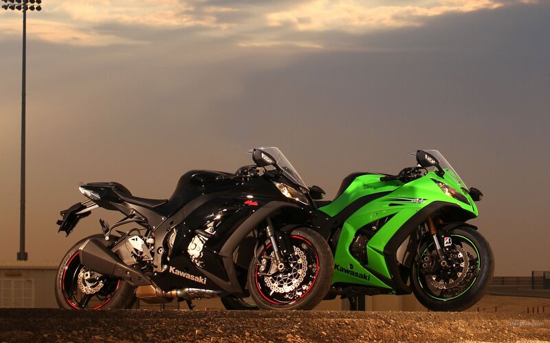Two Kawasaki sport bikes at sunset