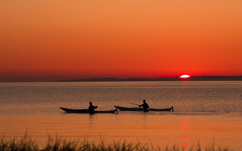 Two Kayakers at Sunset — Orange, Serene
