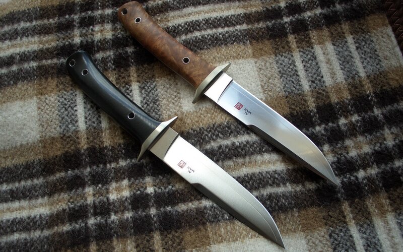 Two knives on a plaid blanket