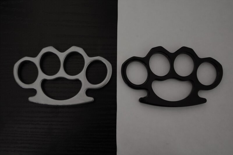Two knuckle dusters on contrasting backgrounds