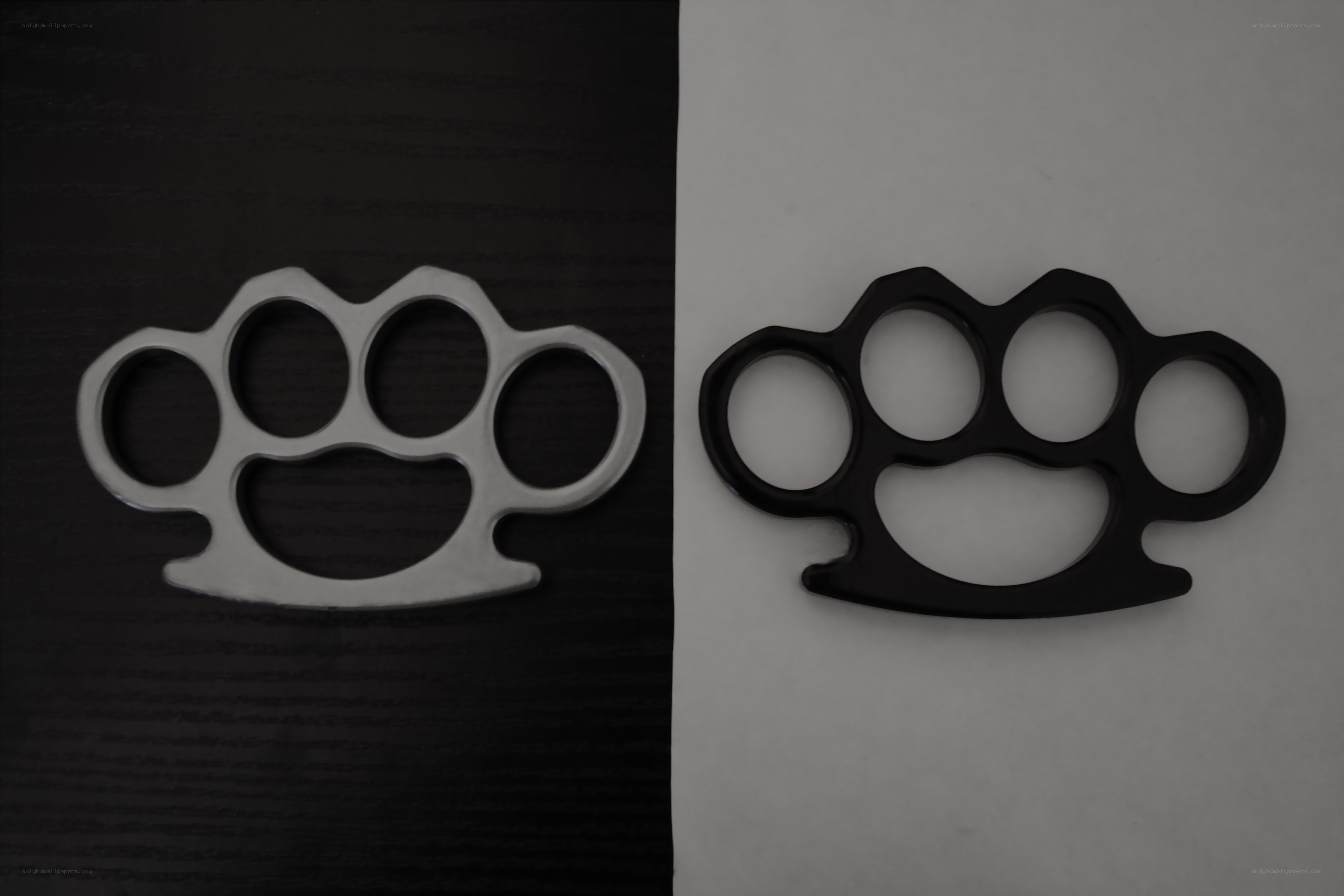 Two knuckle dusters on contrasting backgrounds
