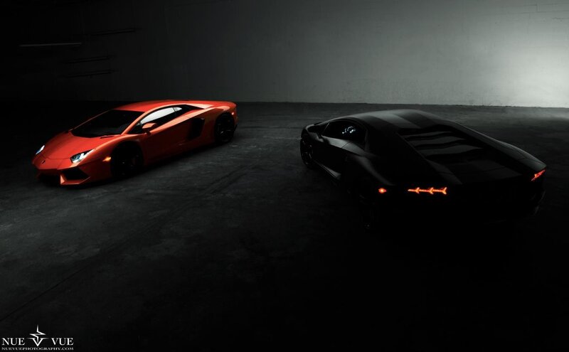 Two Lamborghini Aventadors in a garage