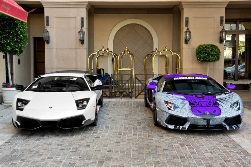 Two Lamborghinis at a hotel entrance