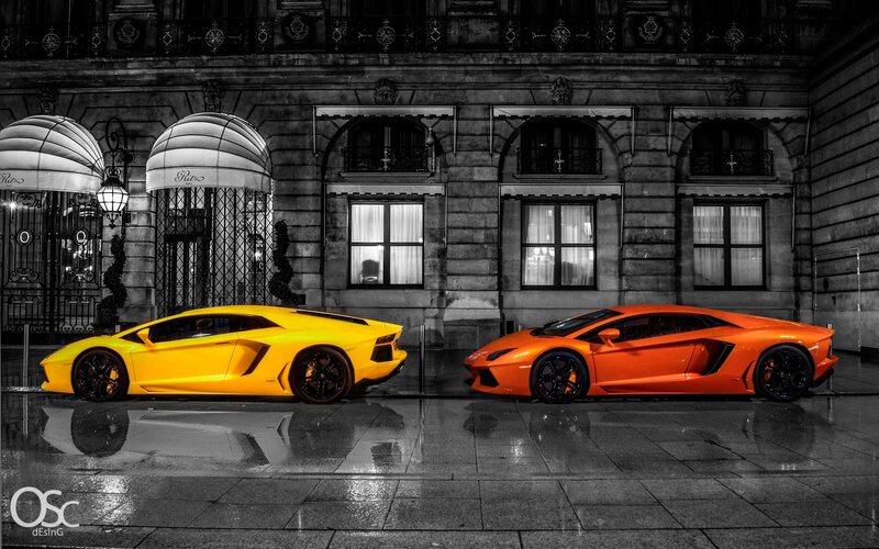 Two Lamborghinis in front of a hotel
