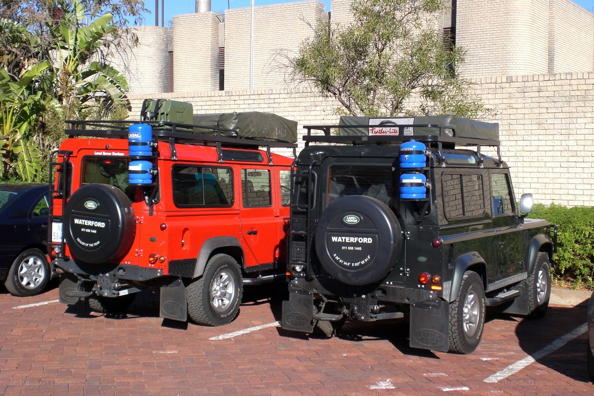 Two Land Rover Defenders parked