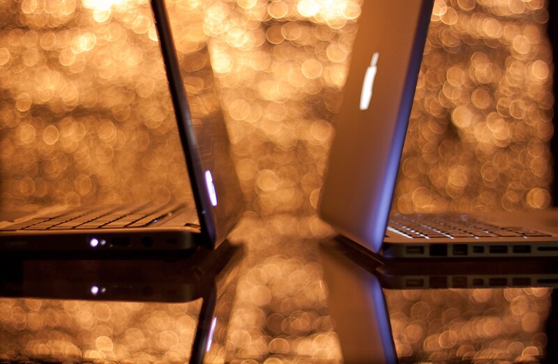 Two Laptops on Reflective Surface