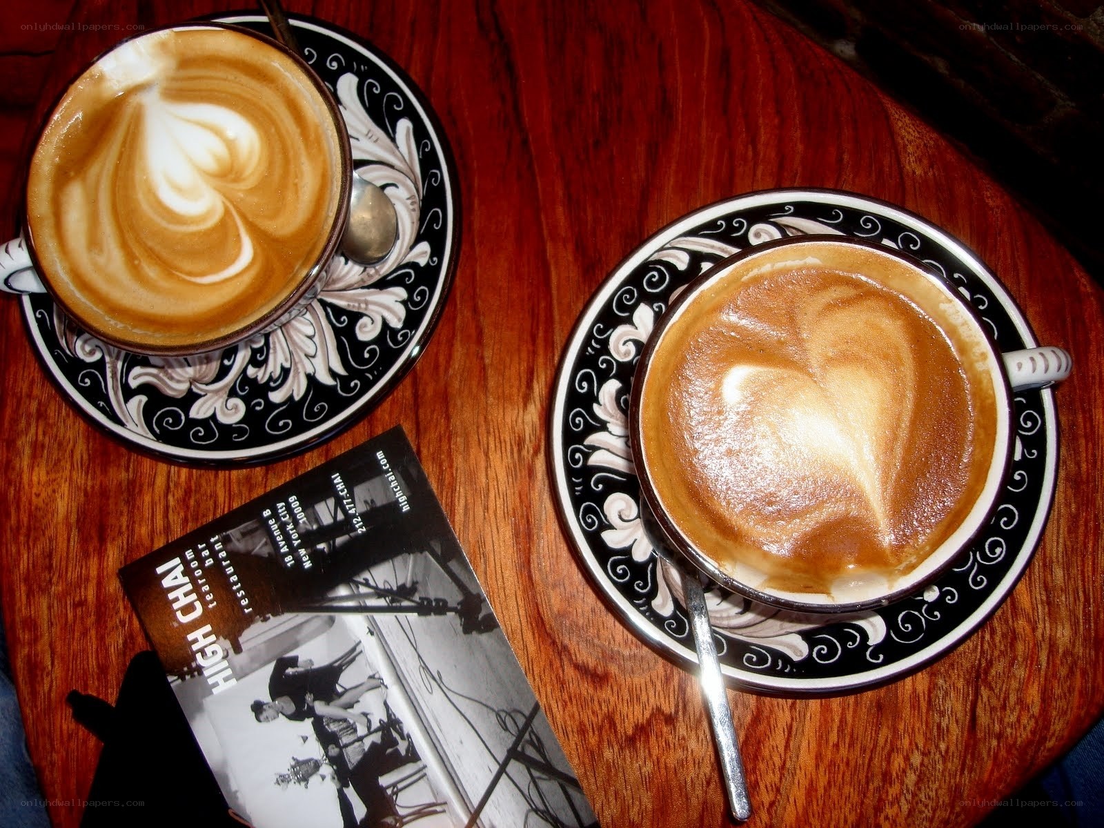 Two lattes on a wooden table