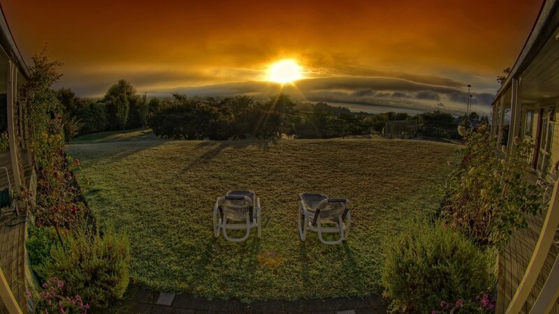 Two Lawn Chairs at Sunset
