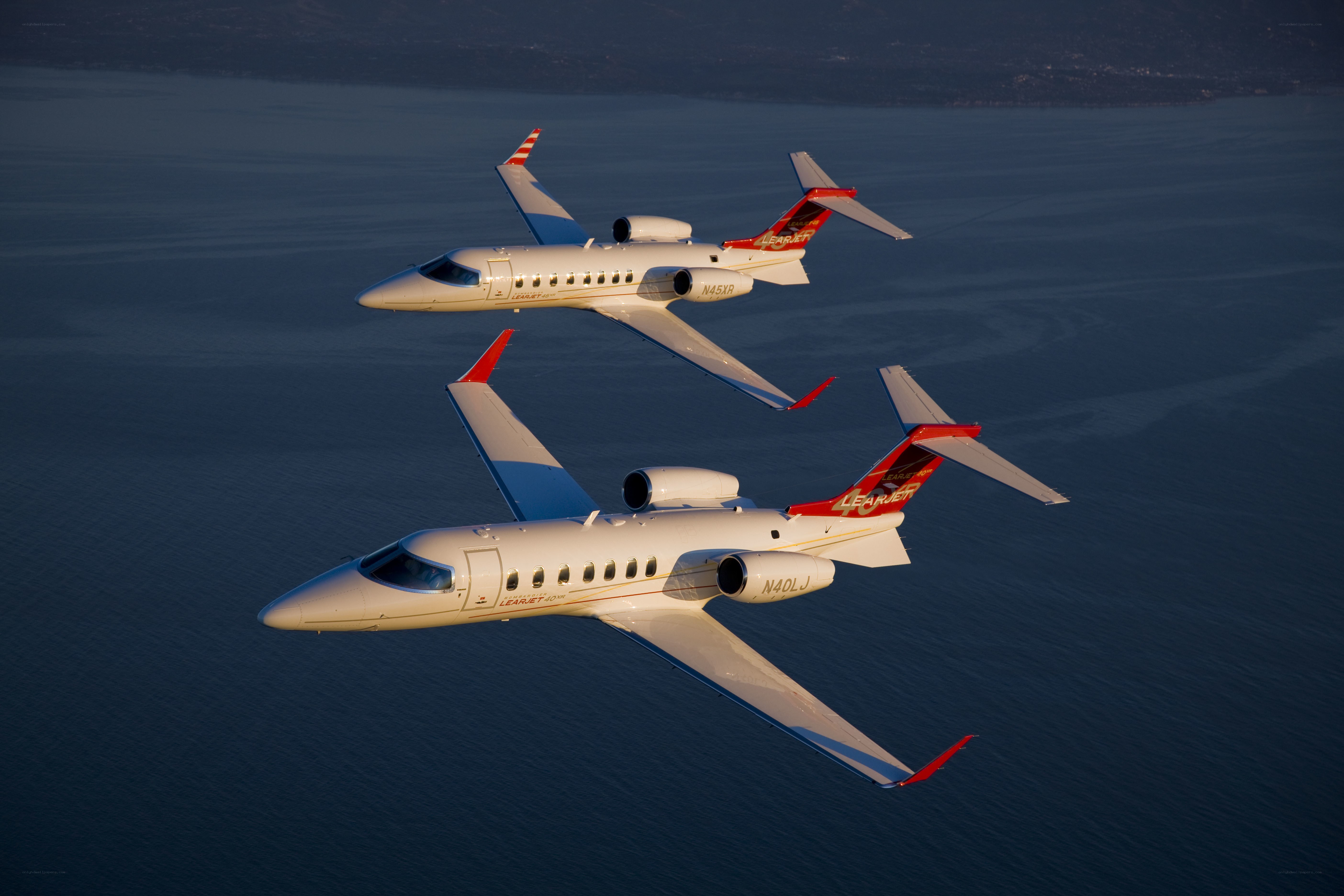 Two Learjet aircraft in flight