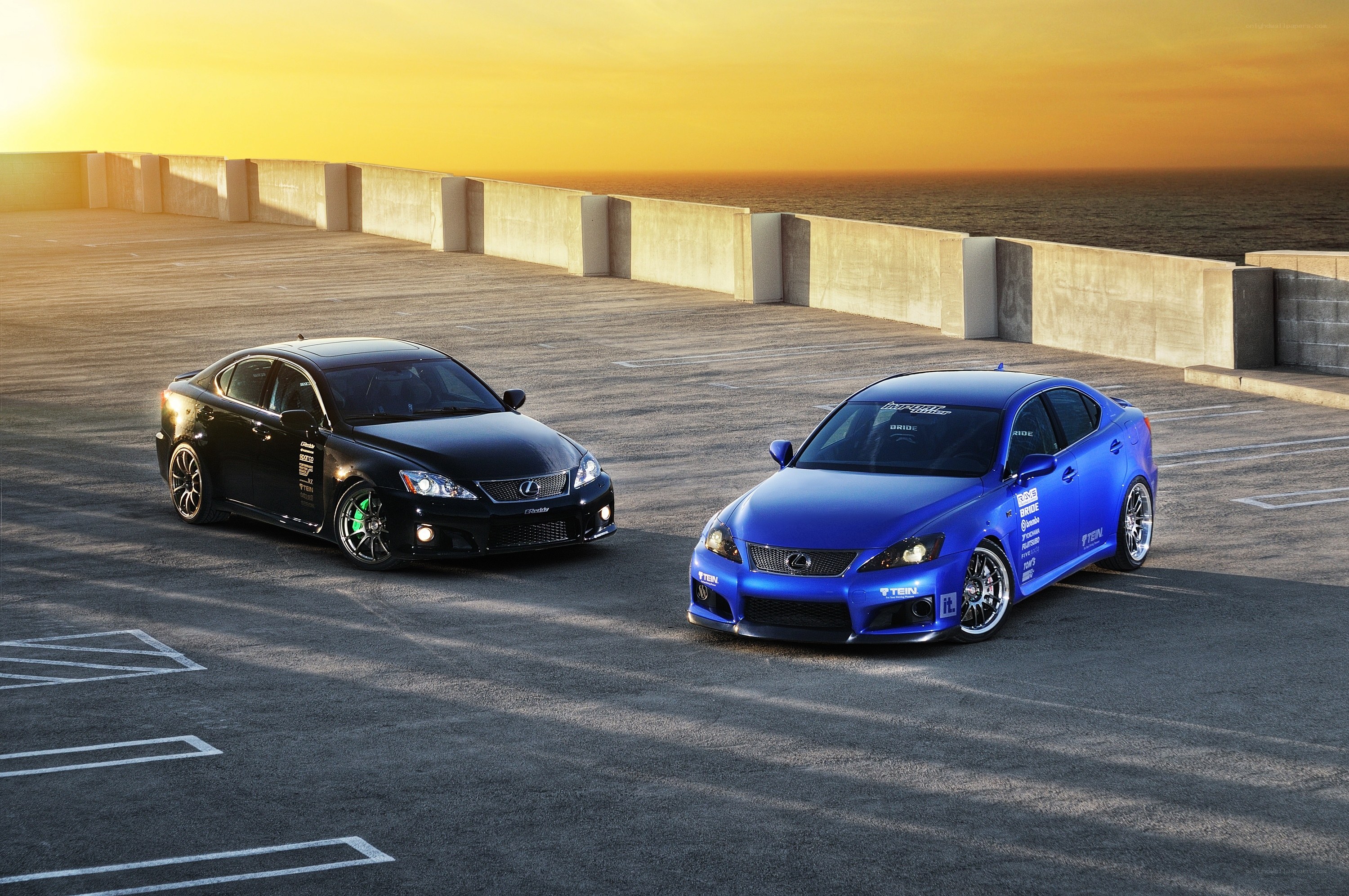 Two Lexus cars at sunset