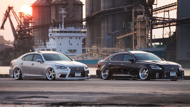 Two Lexus sedans at a port