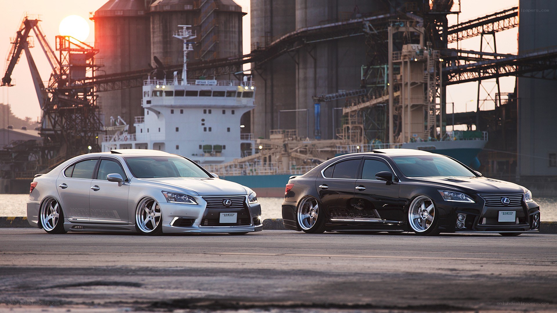 Two Lexus sedans at a port