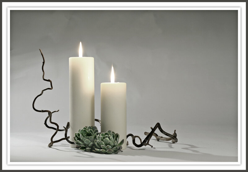 Two Lit Candles and Succulents