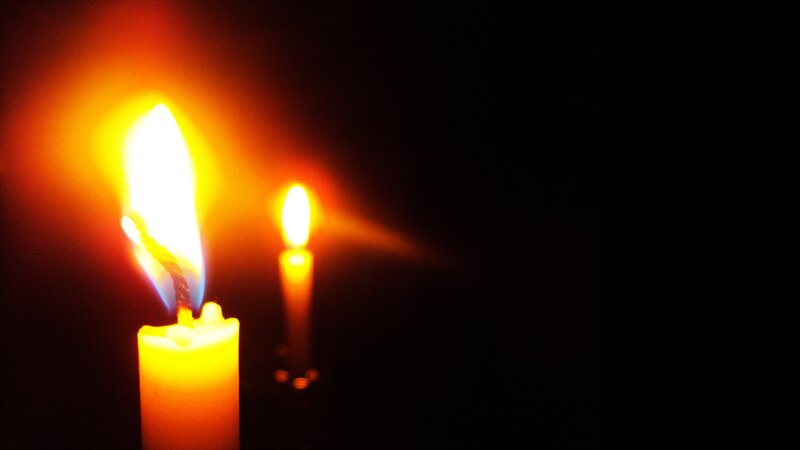 Two Lit Candles — Yellow, Dramatic