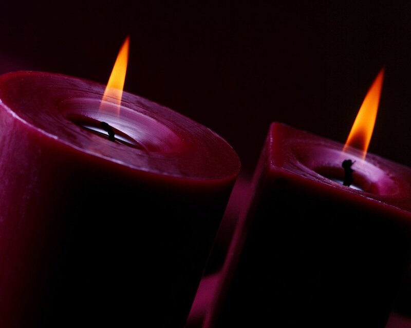 Two lit red candles
