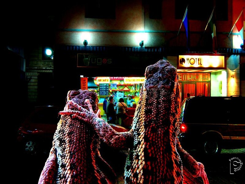 Two lizards in a city at night