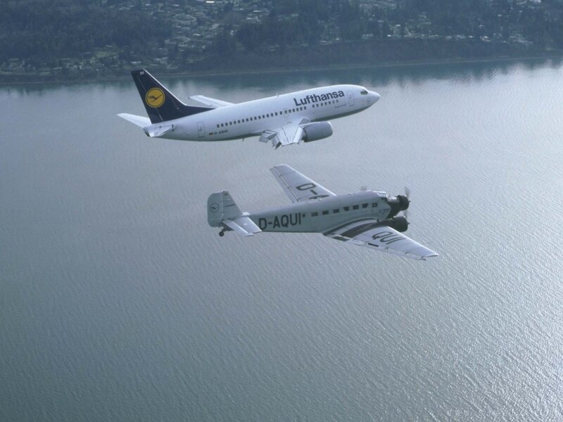 Two Lufthansa planes flying over water